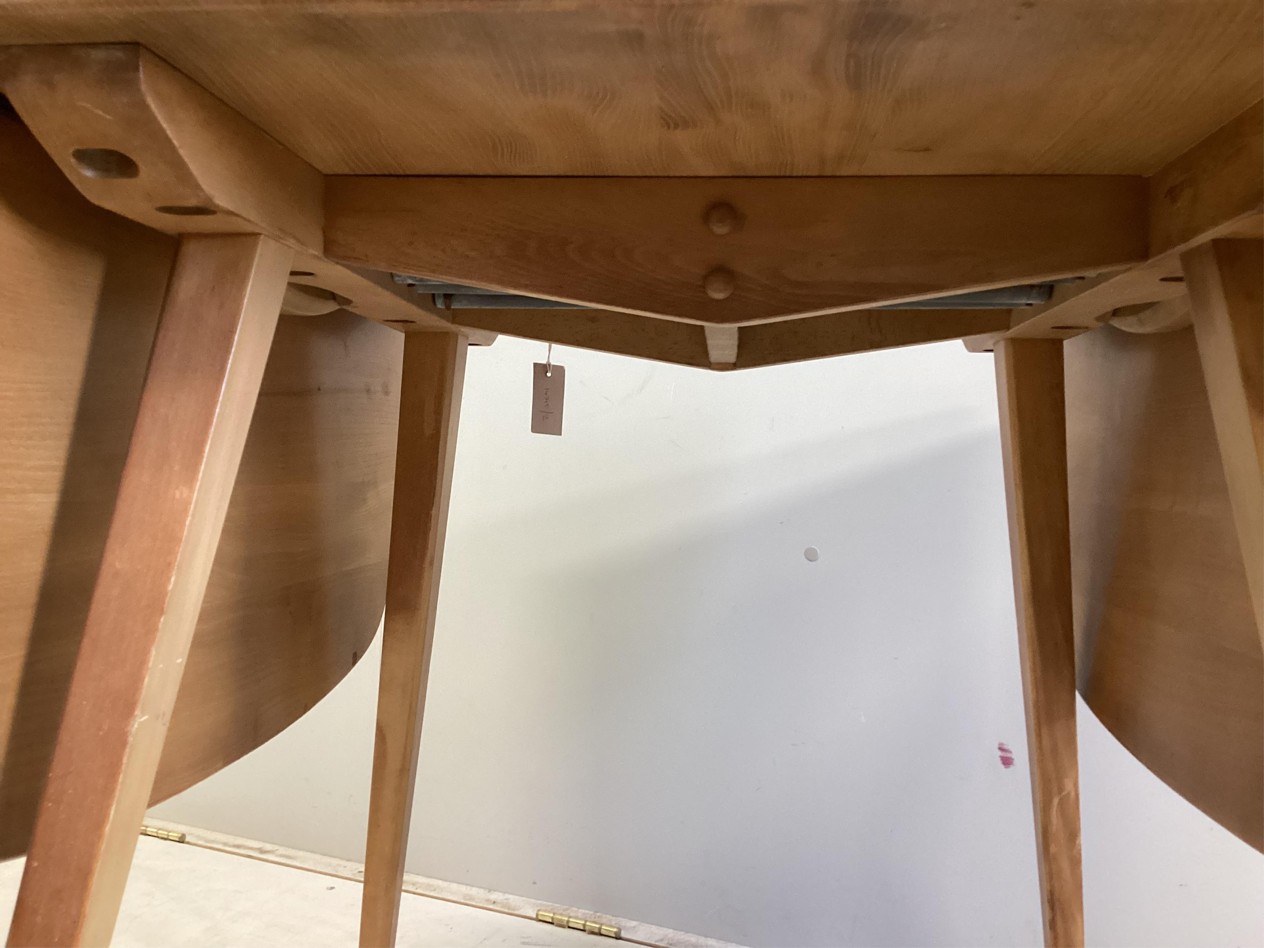 An Ercol pale elm drop leaf dining table, width 140cm extended, depth 74cm, height 71cm